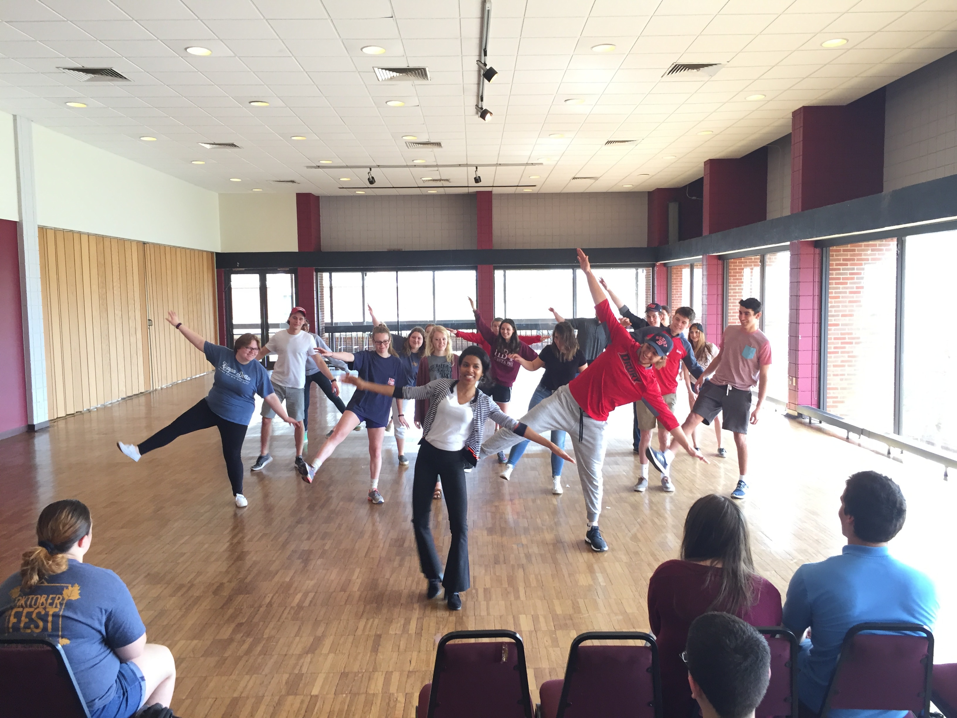 Group fitness class dancing together indoors