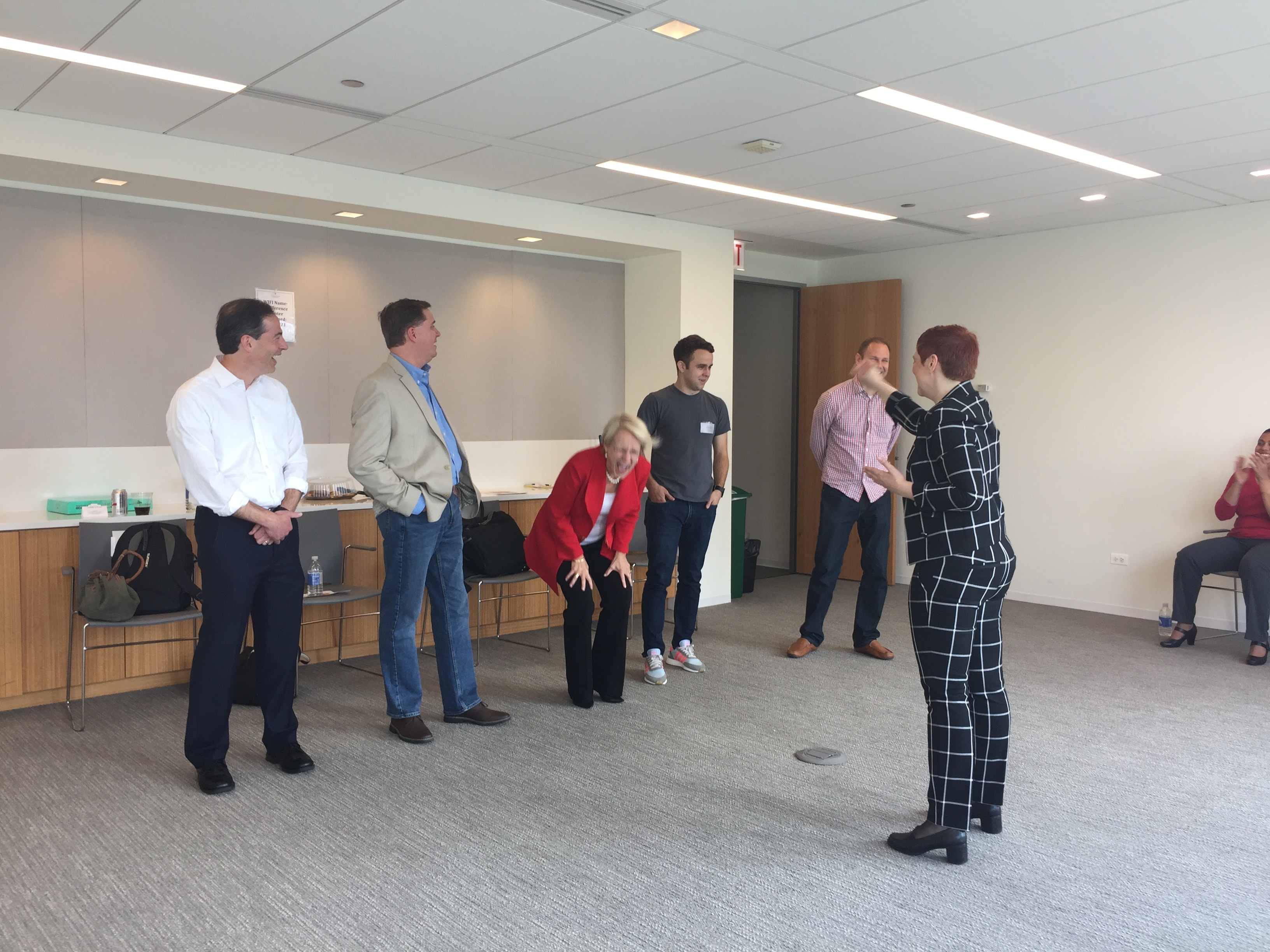 Group of people standing in office meeting room