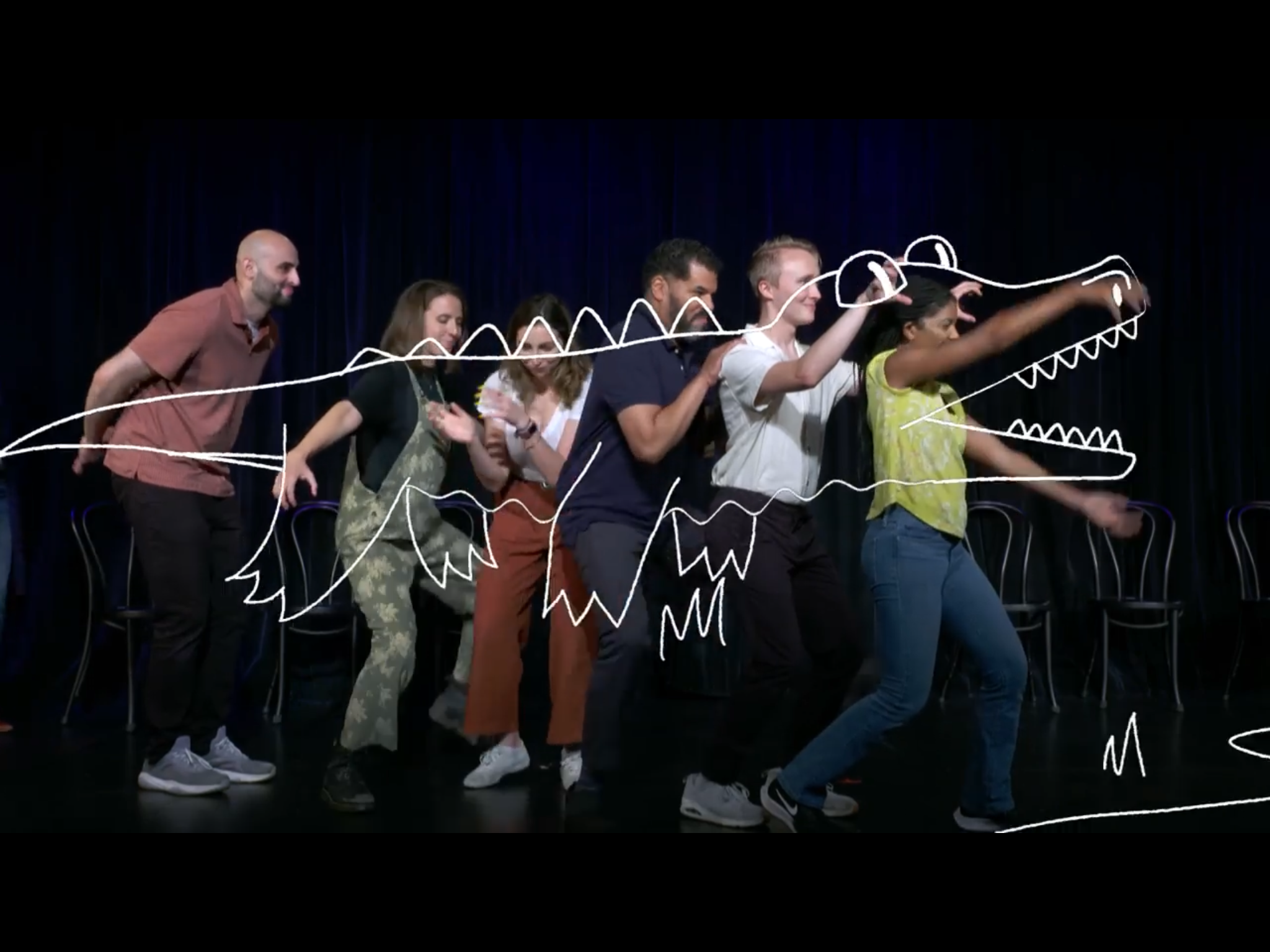 Group performing improv exercise on stage with illustrated overlay