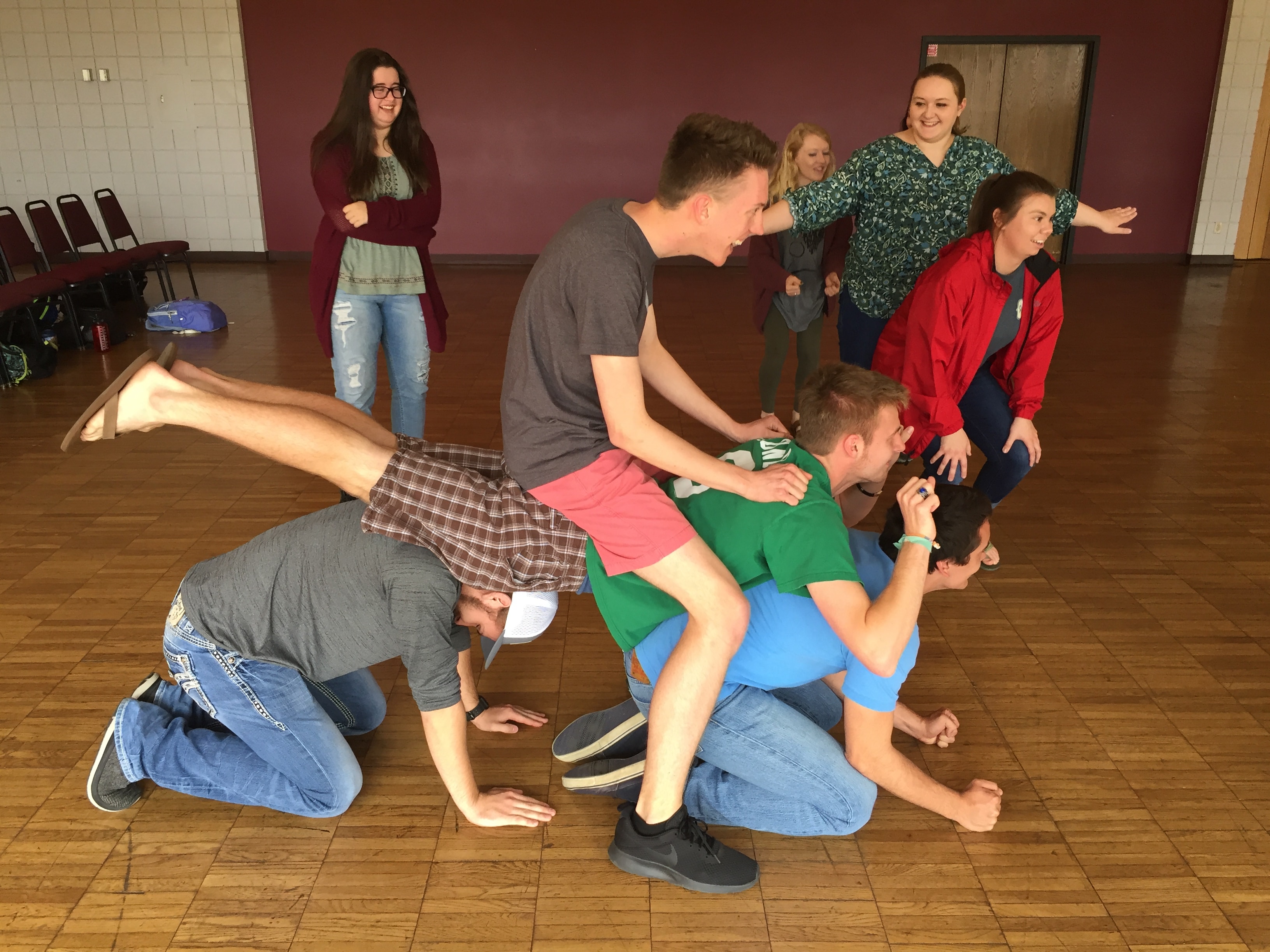 Group playing human chair game